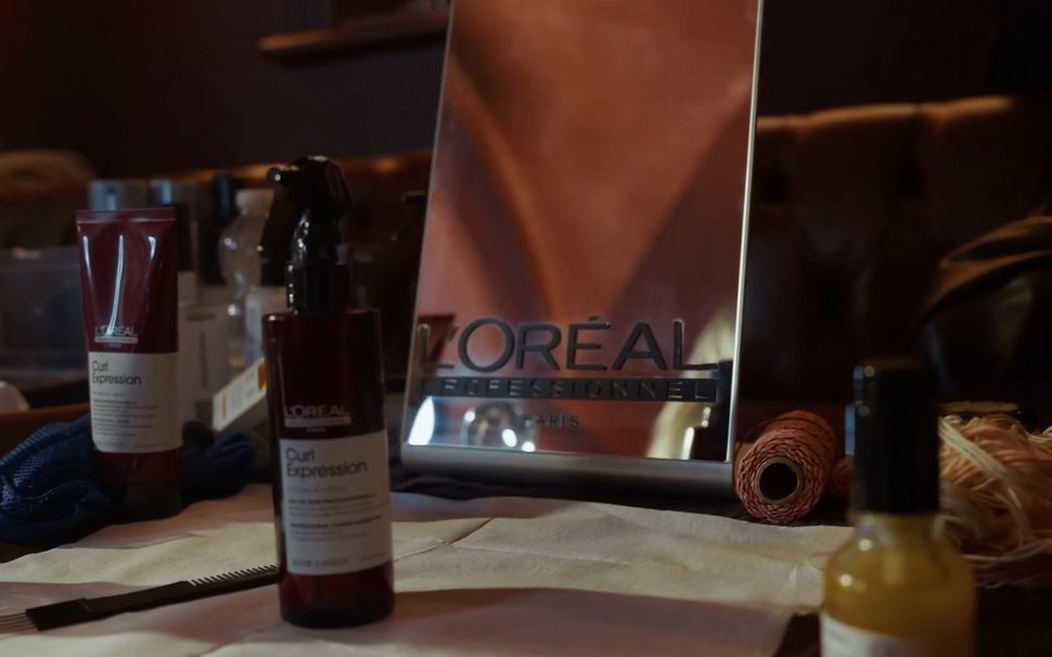 L'Oréal Professionnel mirror, Curl Expression products and a comb laid out on a backstage styling table at Irish Fashion Week